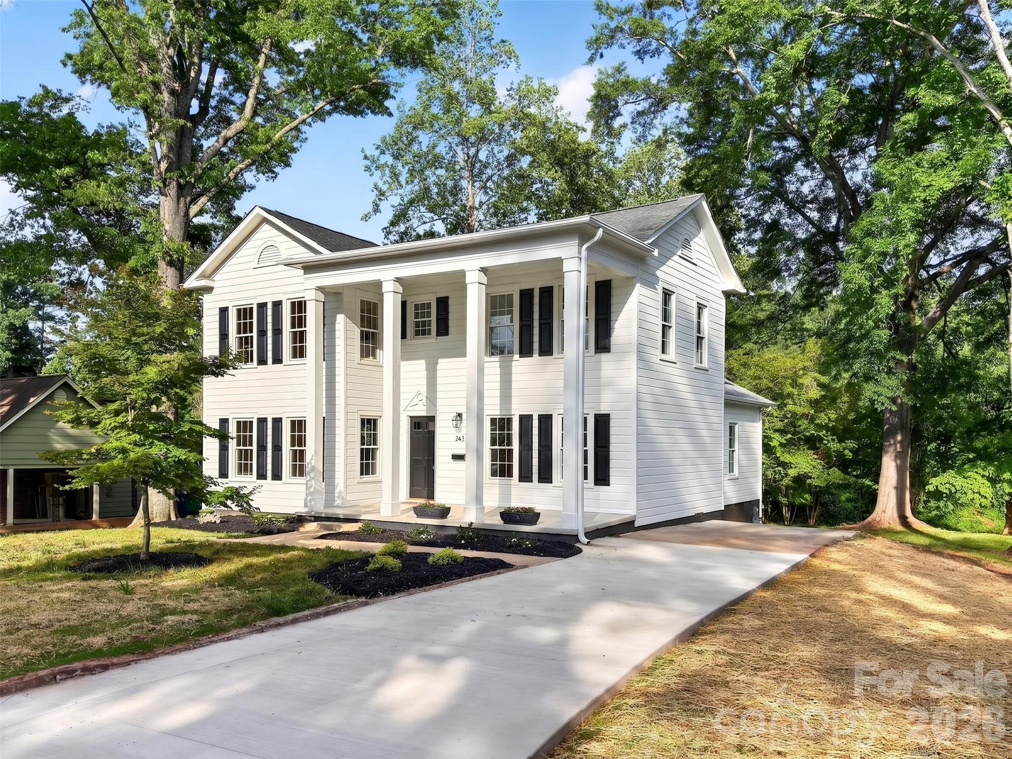 262 Pleasant Street Spindale, NC 28160 - Photo 2 of 37 a front view of a house with a yard and trees