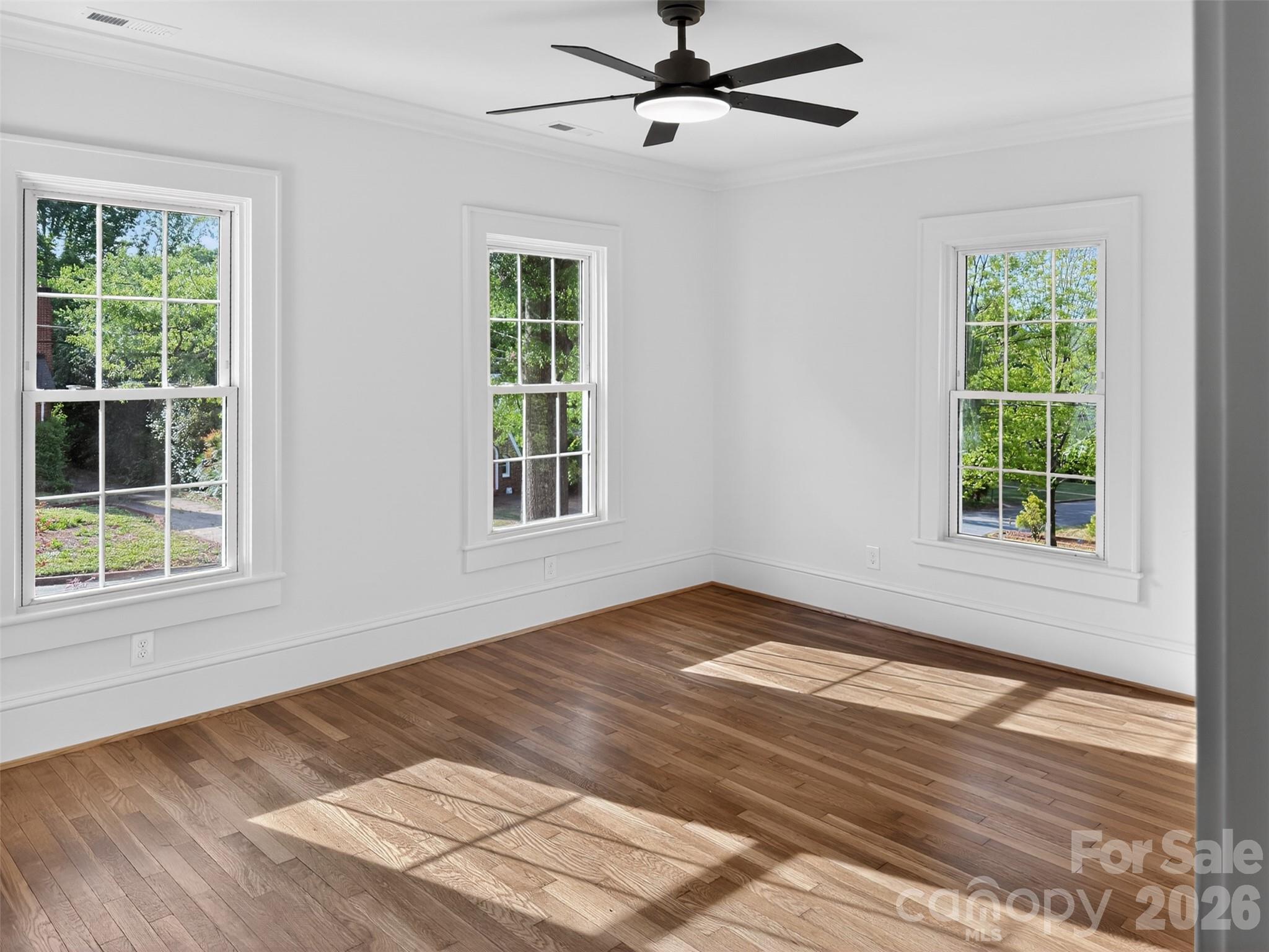 262 Pleasant Street Spindale, NC 28160 - Photo 29 of 37 a view of an empty room with wooden floor and a window