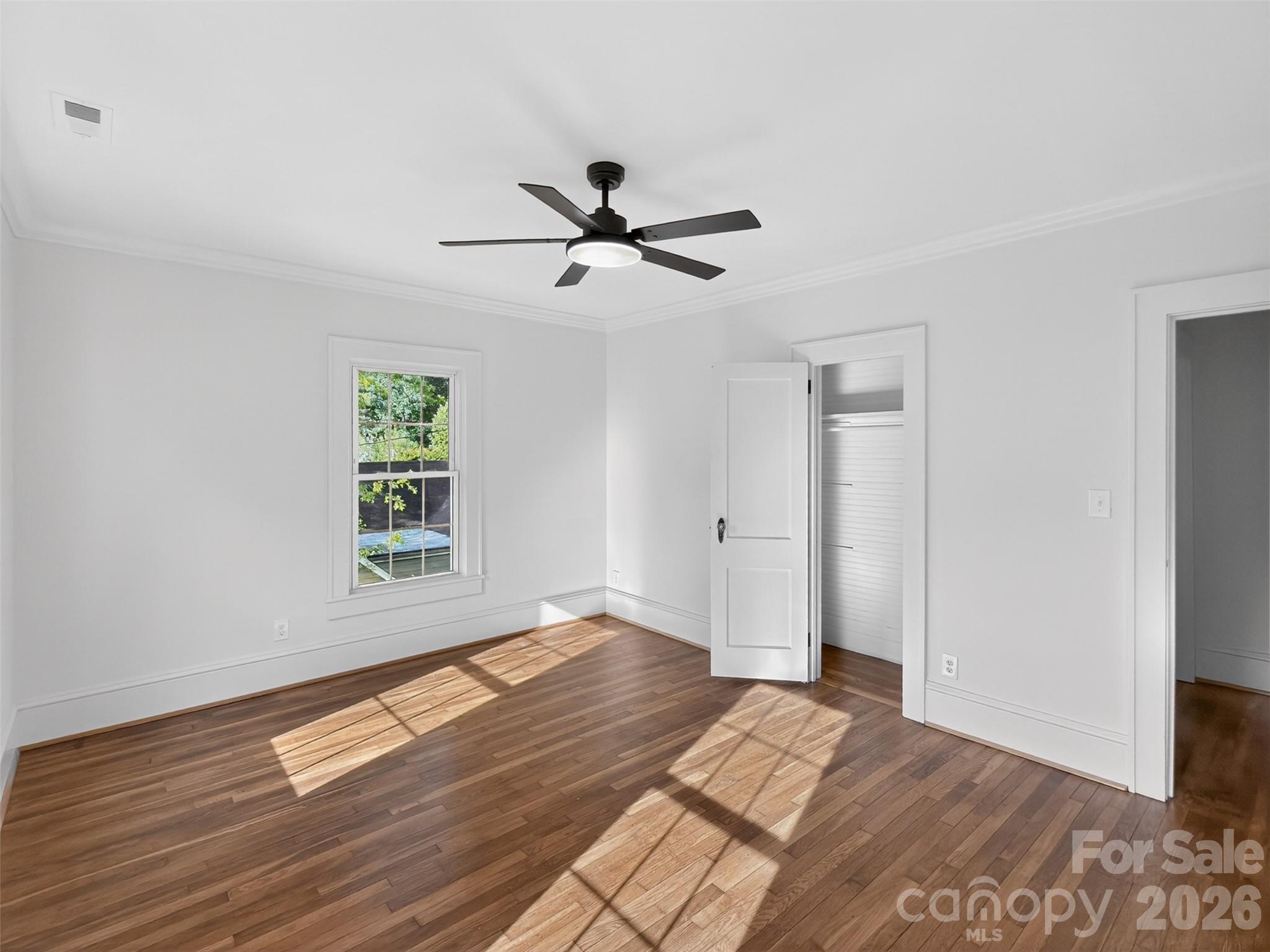 262 Pleasant Street Spindale, NC 28160 - Photo 30 of 37 a view of empty room with wooden floor and fan