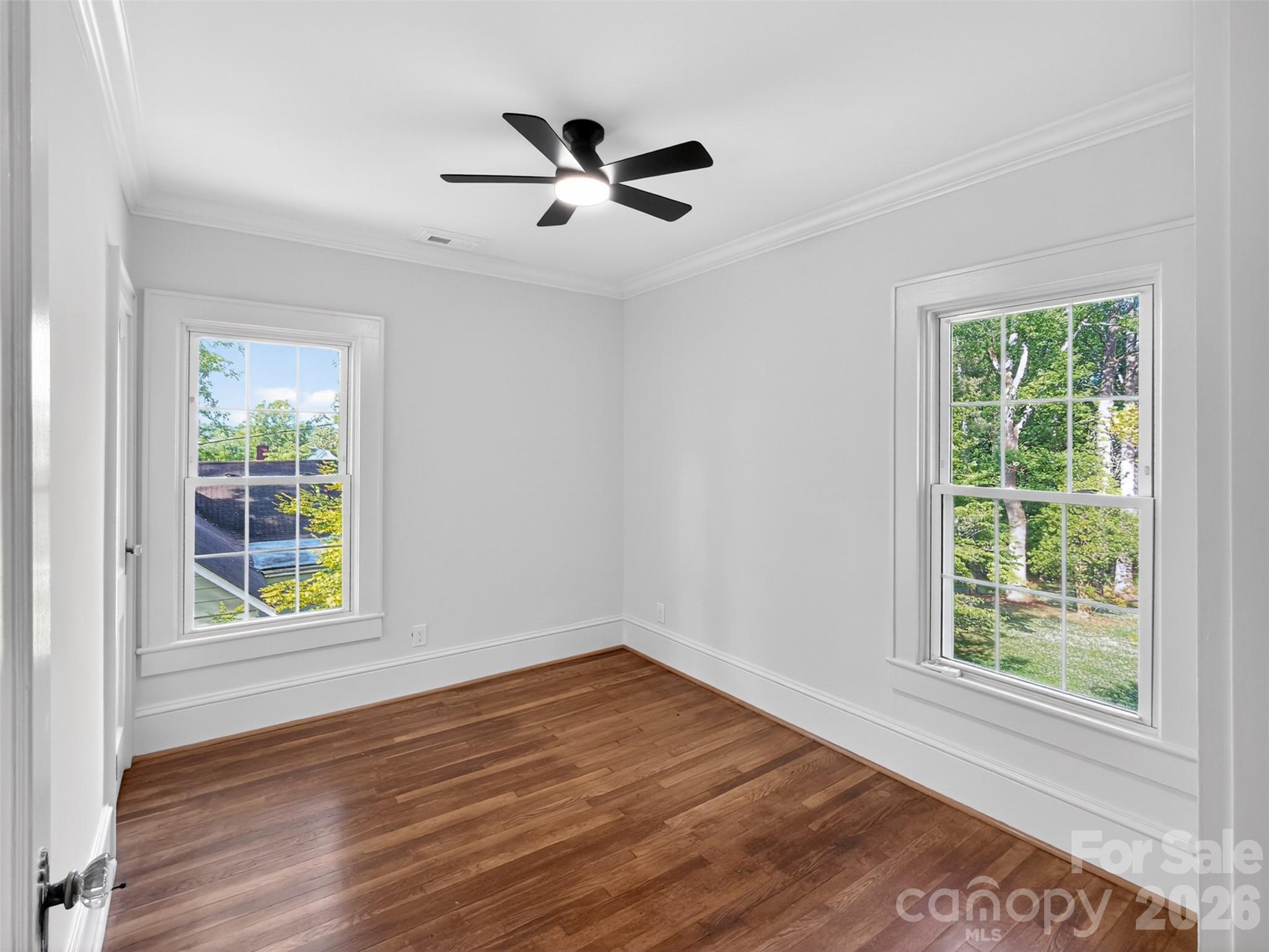 262 Pleasant Street Spindale, NC 28160 - Photo 32 of 37 a view of an empty room with wooden floor and a window