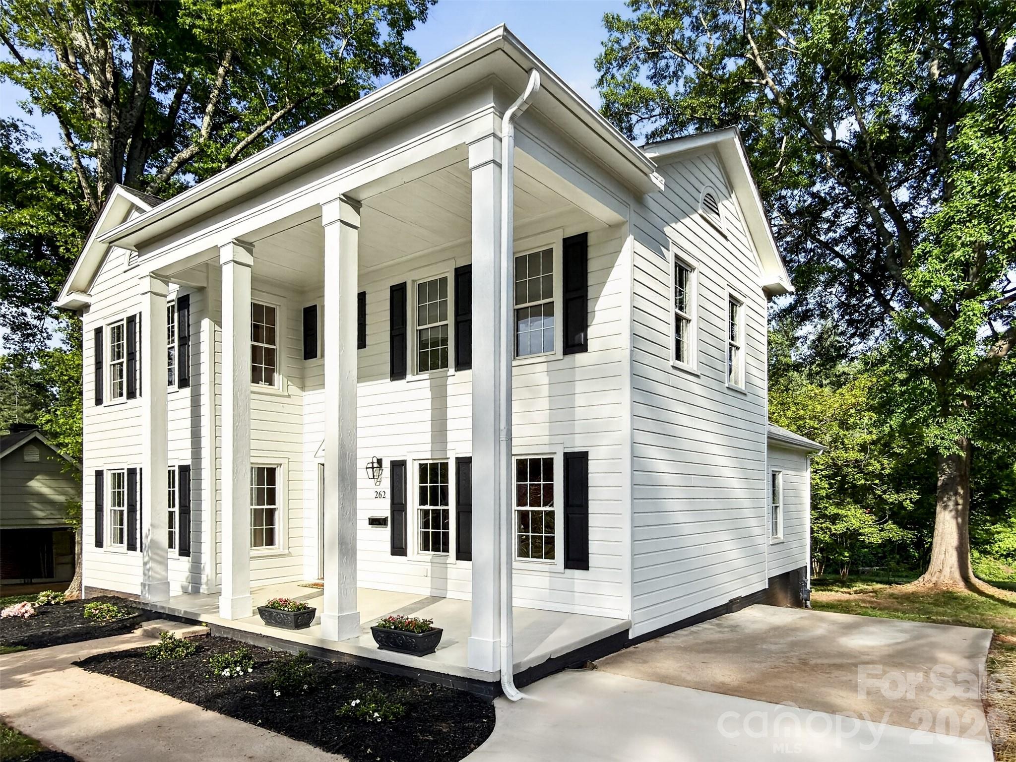 262 Pleasant Street Spindale, NC 28160 - Photo 33 of 37 a view of a white house with large windows