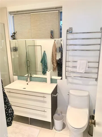 a bathroom with a sink mirror vanity and toilet