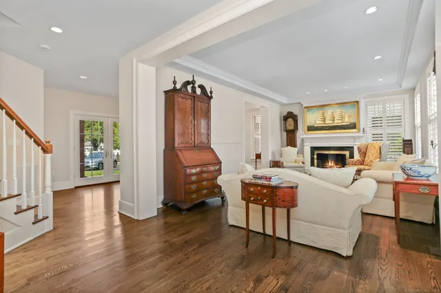 a living room with fireplace furniture and a wooden floor