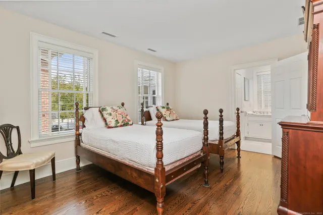 a bed room with a bed and a chair