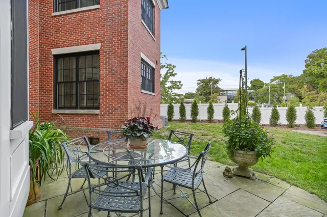 a view of a patio with table and chairs and potted plants