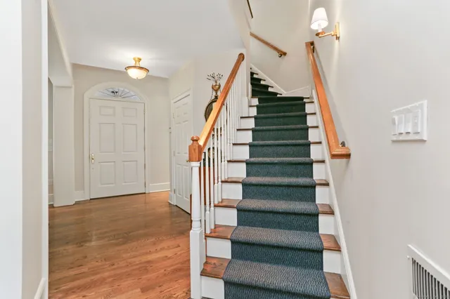 a view of entryway and hall with wooden floor