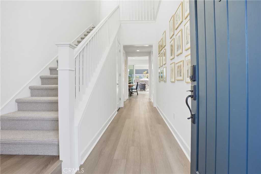 135 Medano Street Rancho Mission Viejo, CA 92694 - Photo 3 of 67 a view of a hallway with wooden floor and staircase