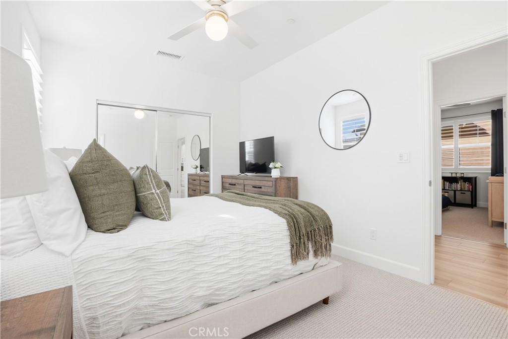 135 Medano Street Rancho Mission Viejo, CA 92694 - Photo 31 of 67 a bedroom with a bed and wooden floor
