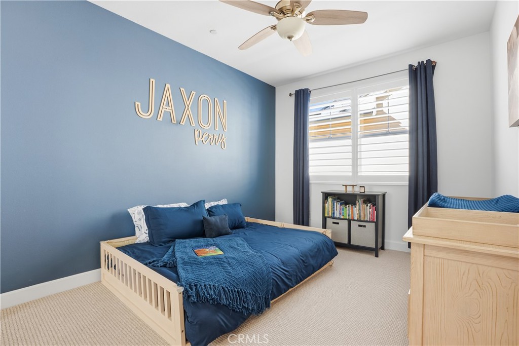 135 Medano Street Rancho Mission Viejo, CA 92694 - Photo 35 of 67 a bedroom with a bed and a chandelier