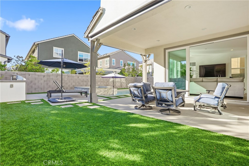 135 Medano Street Rancho Mission Viejo, CA 92694 - Photo 39 of 67 a view of a patio with table and chairs and potted plants