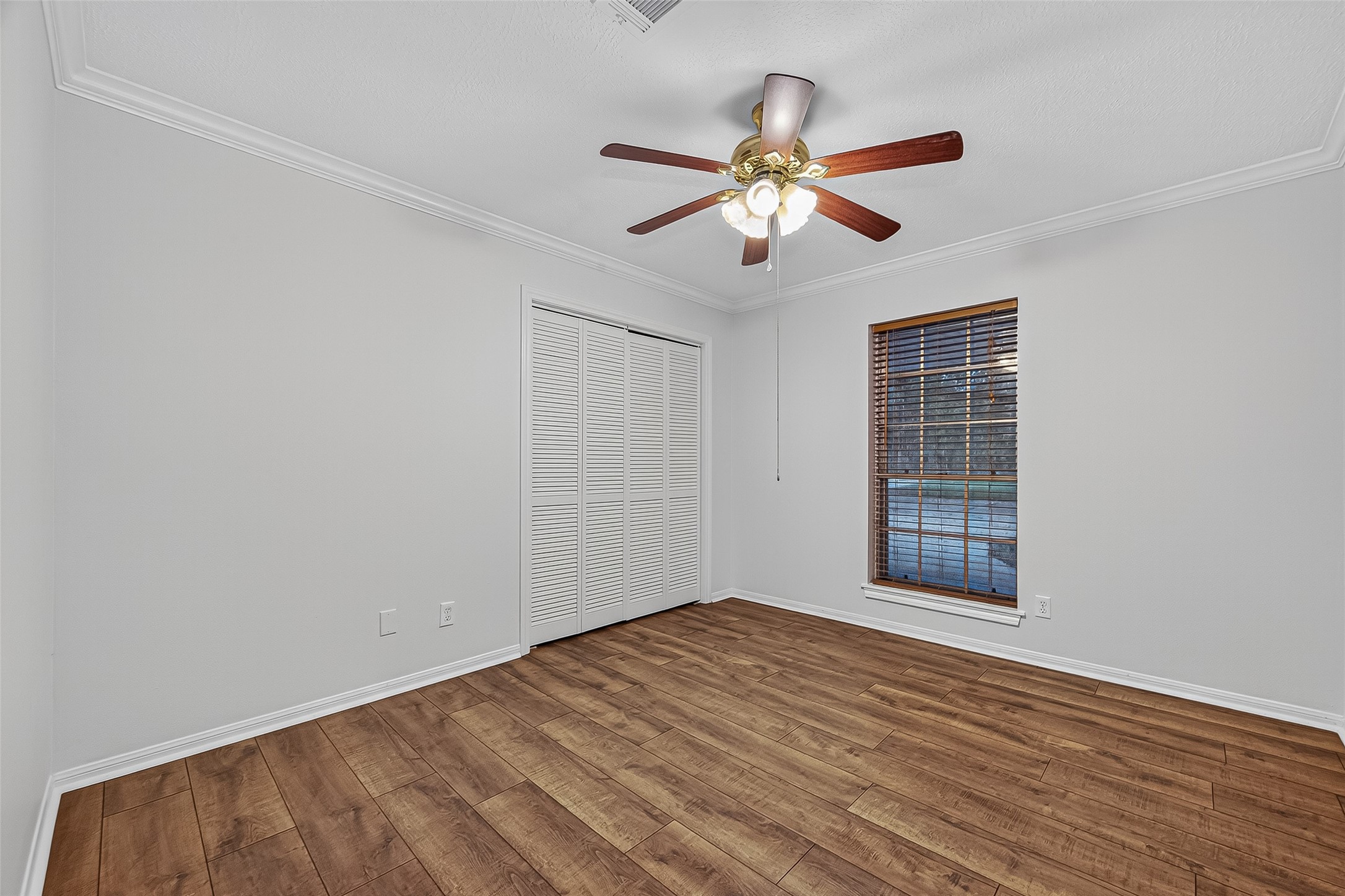 3122 Kueck Road Rosenberg, TX 77471 - Photo 9 of 25 a view of an empty room with wooden floor and a window