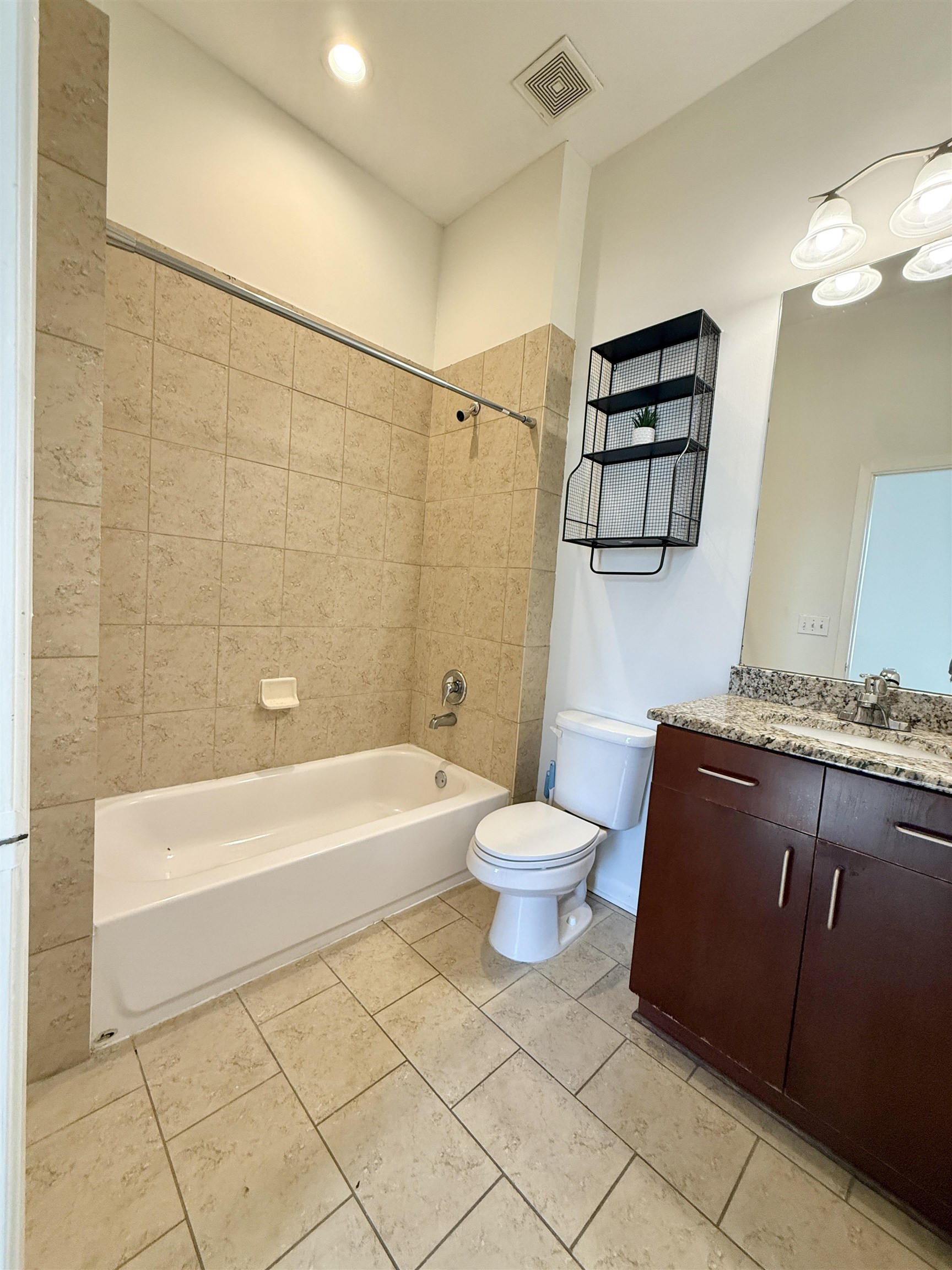 449 Monroe Avenue, Unit 104 Memphis, TN 38103 - Photo 17 of 24 a bathroom with a sink a toilet and bathtub