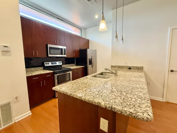 a kitchen with a sink stove and refrigerator