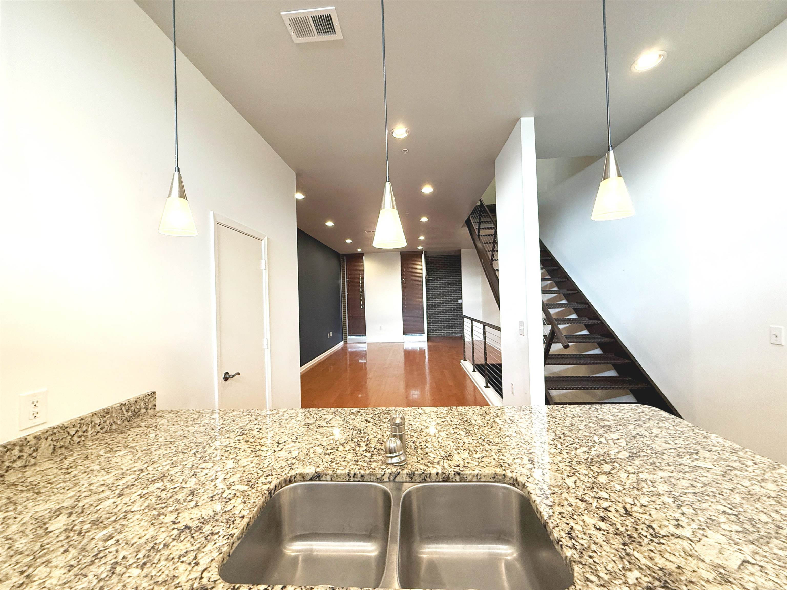 449 Monroe Avenue, Unit 104 Memphis, TN 38103 - Photo 6 of 24 a bathroom with a sink and mirror
