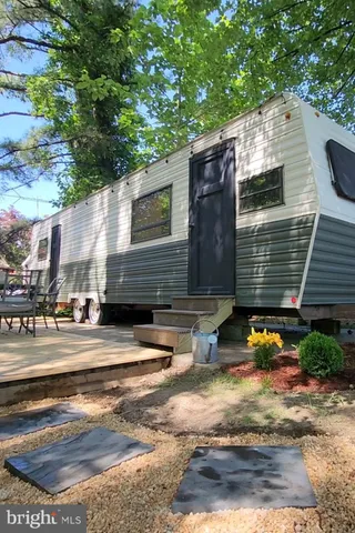 a view of street along with house and trees