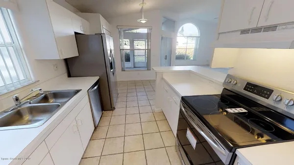 a kitchen with a sink appliances and cabinets