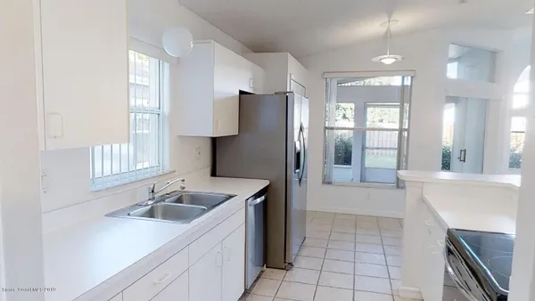 a kitchen with a sink stove and refrigerator