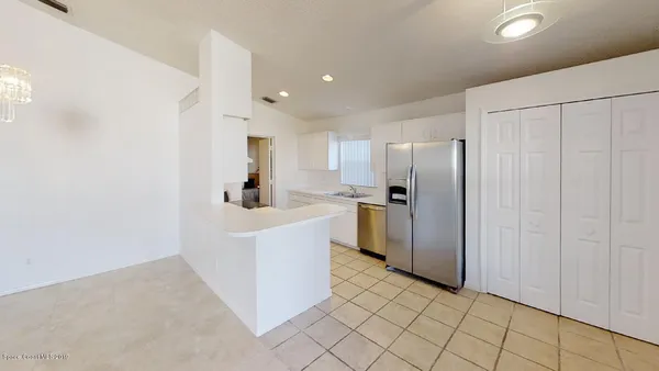 a kitchen with stainless steel appliances a refrigerator and a sink