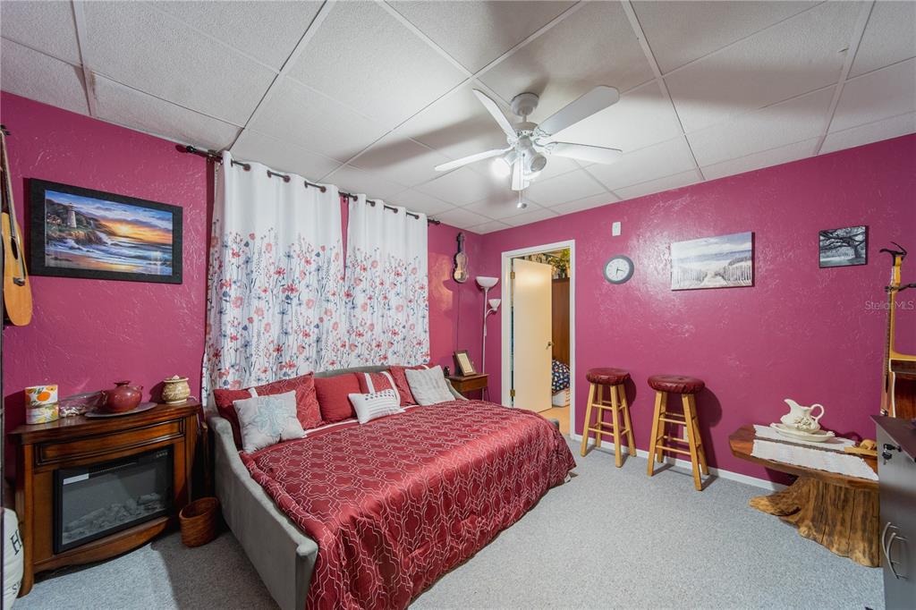 1381 Southeast Lake Road Arcadia, FL 34266 - Photo 13 of 38 a bedroom with a bed and a chandelier