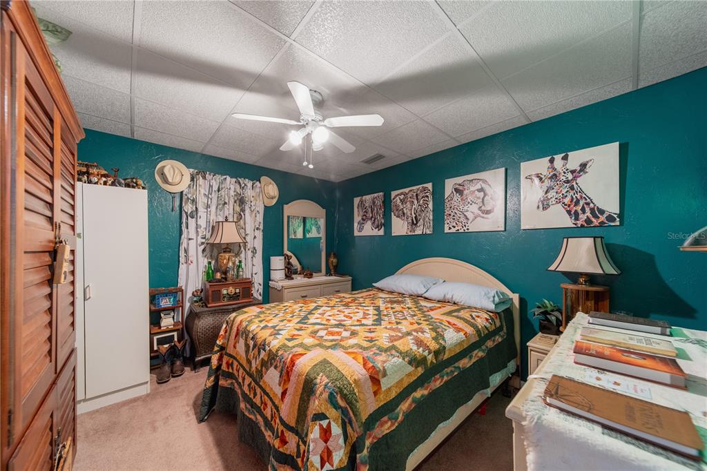 1381 Southeast Lake Road Arcadia, FL 34266 - Photo 15 of 38 a bedroom with a bed and a dresser next to a window