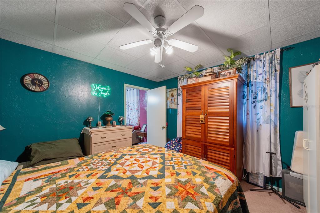1381 Southeast Lake Road Arcadia, FL 34266 - Photo 16 of 38 a bedroom with a bed and a chandelier