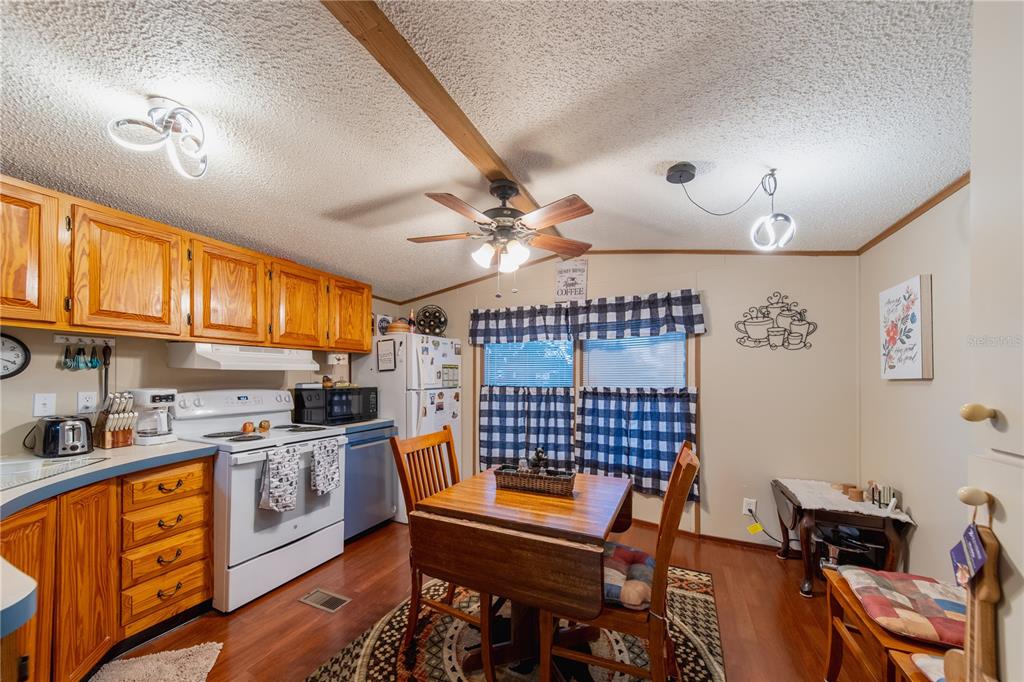 1381 Southeast Lake Road Arcadia, FL 34266 - Photo 19 of 38 a kitchen with stainless steel appliances granite countertop a stove a sink dishwasher and cabinets with wooden floor