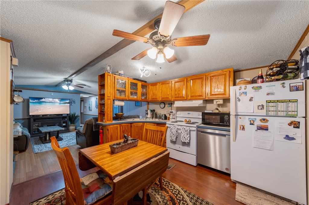1381 Southeast Lake Road Arcadia, FL 34266 - Photo 20 of 38 a kitchen with stainless steel appliances a stove a refrigerator and a dining table
