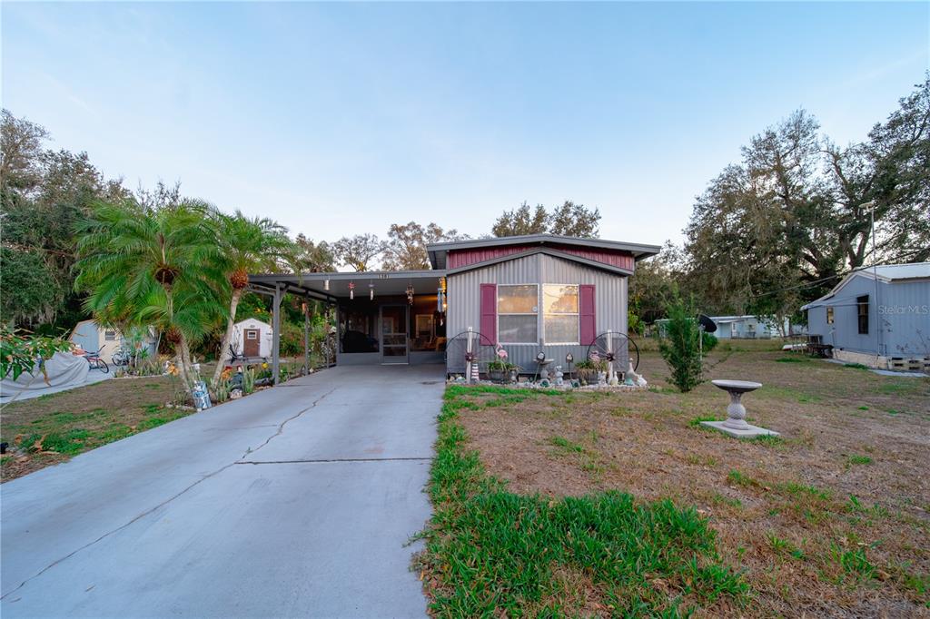 1381 Southeast Lake Road Arcadia, FL 34266 - Photo 23 of 38 a front view of a house with a yard and garage
