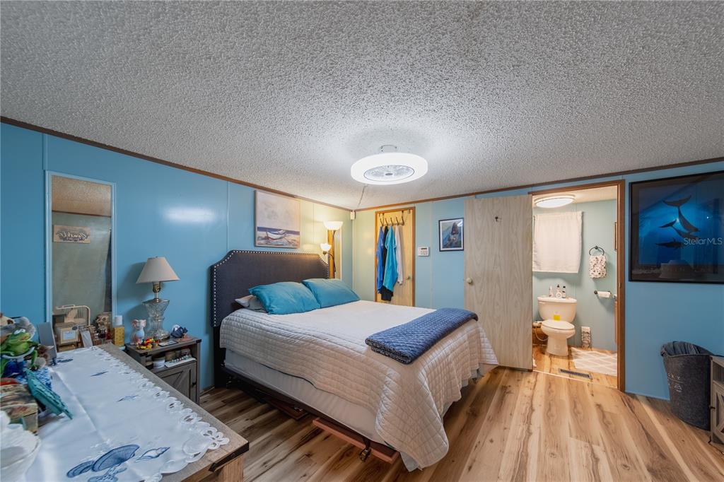 1381 Southeast Lake Road Arcadia, FL 34266 - Photo 7 of 38 a bedroom with a bed and wooden floor
