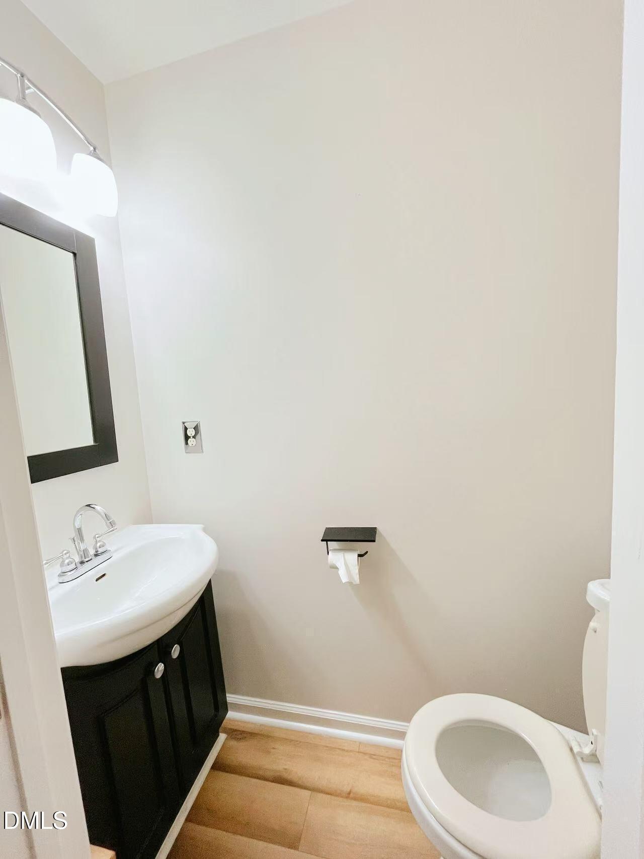 3040 Barrymore Street, Unit 108 Raleigh, NC 27603 - Photo 3 of 13 a bathroom with a sink a toilet and a mirror