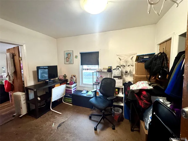 a view of a livingroom with workspace and a couch