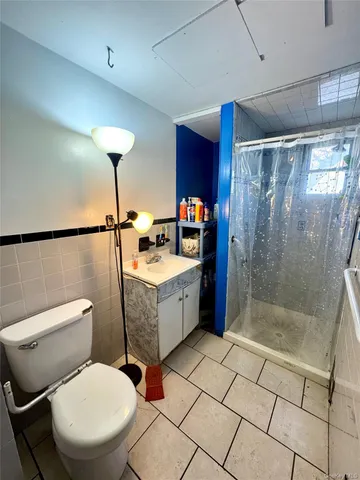 a bathroom with a toilet a sink and a shower