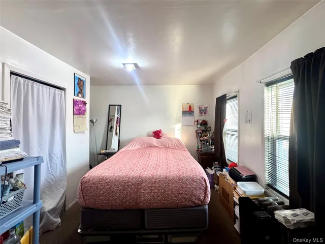 a bed room with a bed and a window