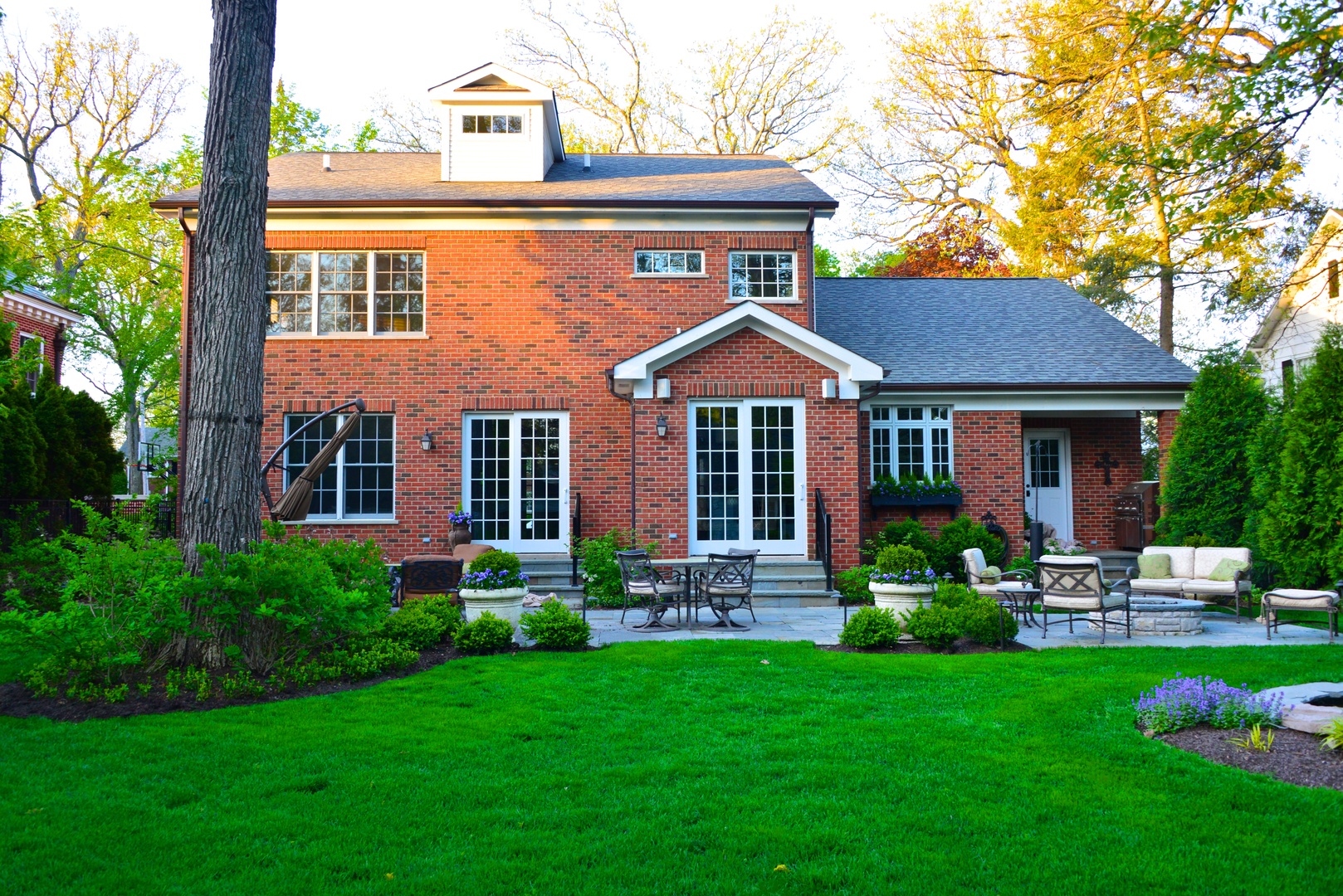 373 Elder Lane Winnetka, IL 60093 - Photo 37 of 53 a front view of a house with a yard table and chairs