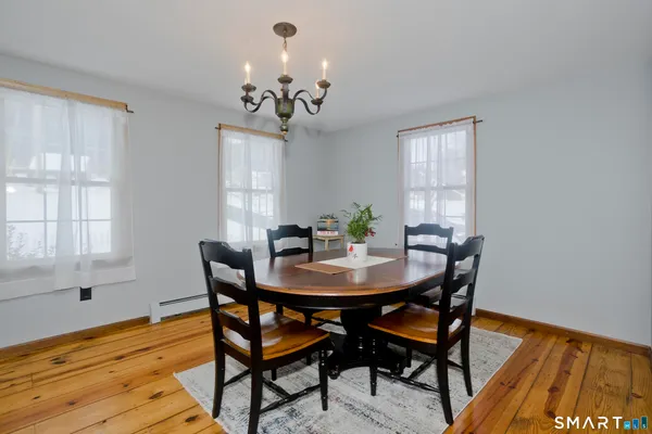 a view of a dining room with furniture and wooden floor