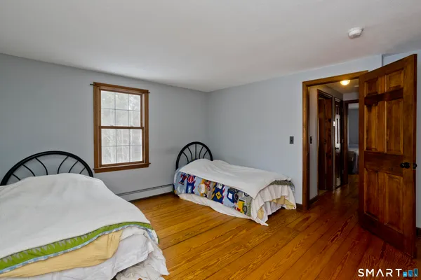 a living room with a bed furniture and a window