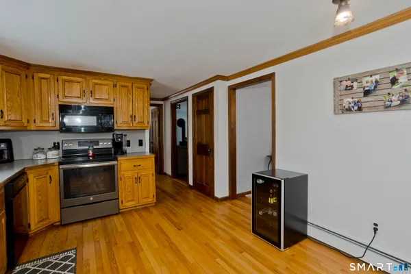 a kitchen with stainless steel appliances granite countertop a refrigerator and a stove top oven