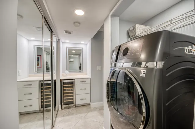a utility room with sink dryer and washer