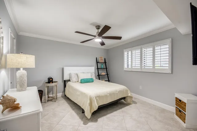 a bedroom with a bed and a lamp on the dresser