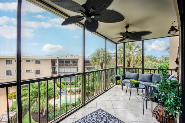 a view of a porch with furniture and a yard