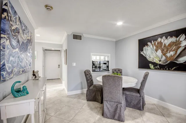 a view of a dining room with furniture and a potted plant
