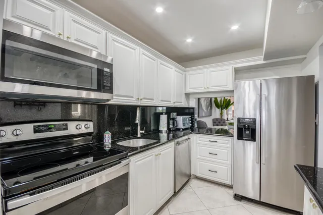 a kitchen with stainless steel appliances and cabinets