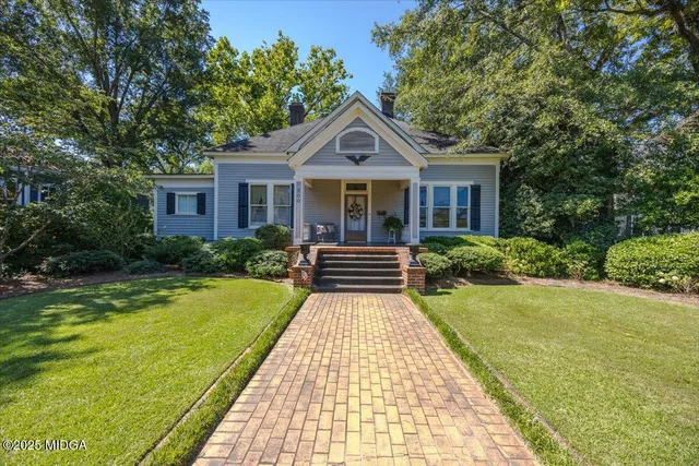 a front view of house with yard and green space