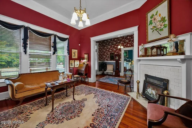 a view of a dining room with furniture a chandelier and wooden floor