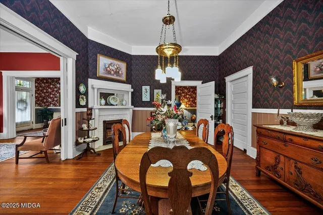a dining room with furniture window fireplace and wooden floor