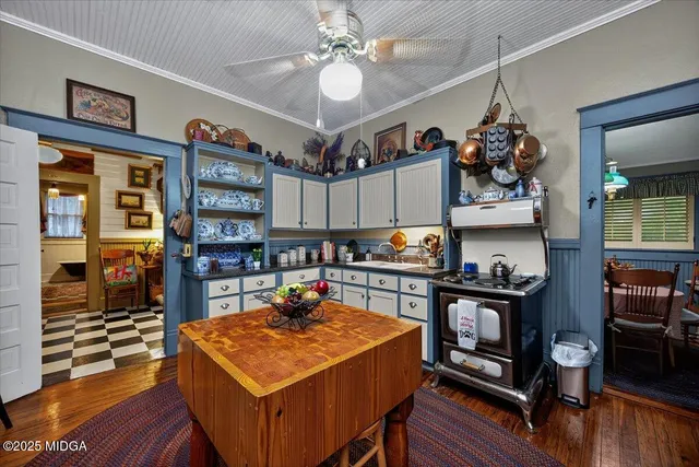 a kitchen with stainless steel appliances a stove refrigerator sink and cabinets