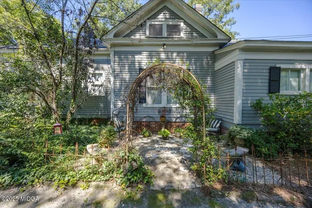 a view of a house with a tree