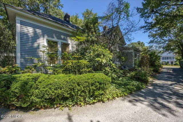 a view of a house with a tree in front