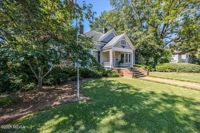 a bedroom with furniture and a large window