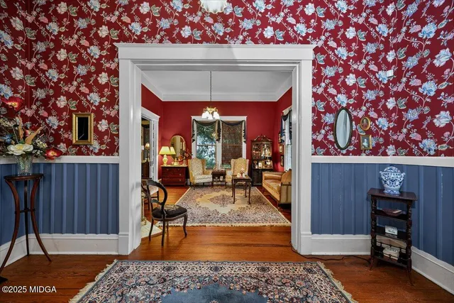 a living room with furniture a fireplace and a chandelier
